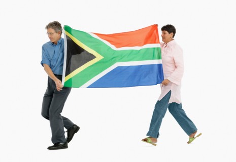 Two people carrying the South African flag. Photo : momentimages