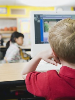 Elementary students working on computers.