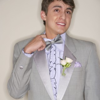 Man wearing grey tuxedo.