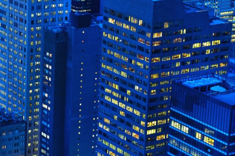 Illuminated buildings in New York City at sunset.