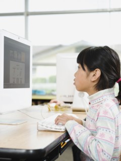 Student working on computer in classroom.