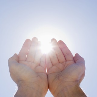 Hands framing sunshine.
