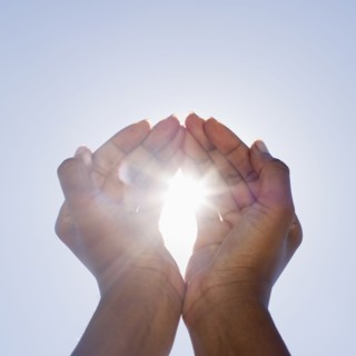 Hands framing sunshine.