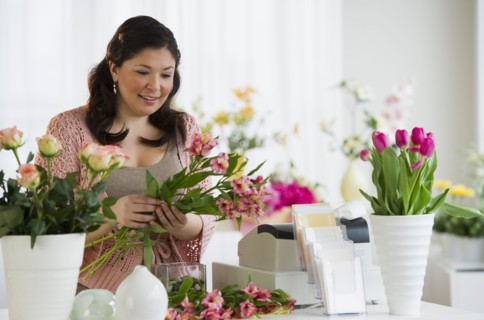 Florist making a floral arrangement.