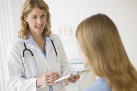 Doctor talking to patient in exam room.