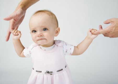 Baby holding father`s fingers.
