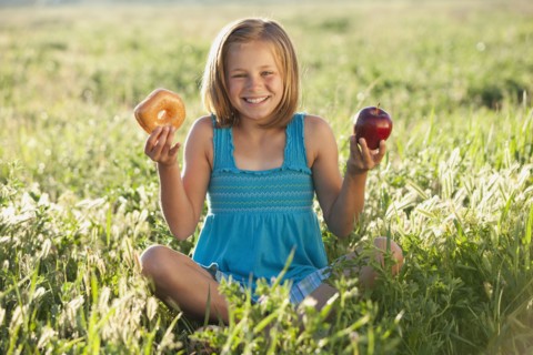 Young girl making food choice. Photo. Mike Kemp
