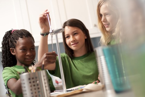 Group of children looking at model windmill. Photo : Tim Pannell
