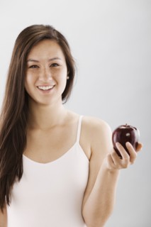 Woman holding a red apple. Photo. FBP