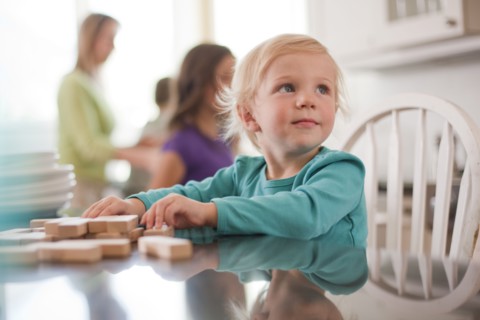Young girl playing with wooden blocks. Photo : Tim Pannell