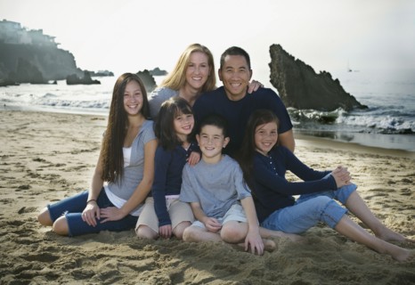 Family sitting together at the beach. Photo. FBP