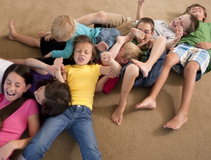 Group of children playing on floor. Photo : Tim Pannell