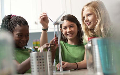 Group of children looking at model windmill. Photo : Tim Pannell