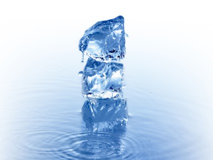 Stack of ice cubes in water. Photo. David Arky