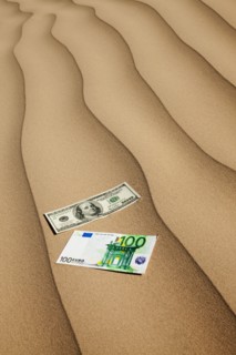Money on sand in desert. Photo : Mike Kemp