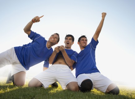 Three happy soccer players. Photo : Mike Kemp