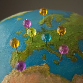 Push pins on globe. Photo : Mike Kemp
