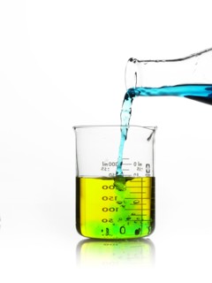 Blue liquid being poured into measuring cup. Photo : David Arky