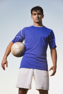 Soccer player holding ball. Photo. Mike Kemp