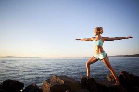Athletic woman stretching outdoors. Photo : Take A Pix Media