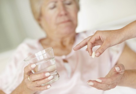 Nurse giving pill to senior woman. Photo : momentimages