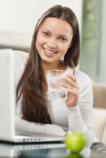 Woman drinking a glass of water. Photo. momentimages