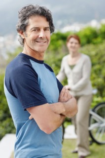 Handsome man standing with his arms crossed. Photo. momentimages