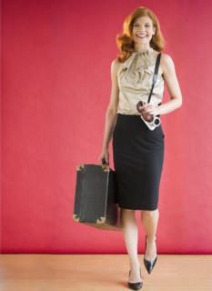 Attractive woman carrying a suitcase. Photo : Jamie Grill