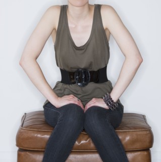Woman sitting on ottoman. Photo. Daniel Grill