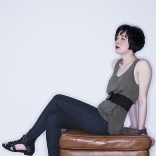 Woman sitting on ottoman. Photo. Daniel Grill