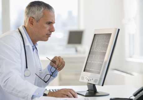 Doctor working on computer.