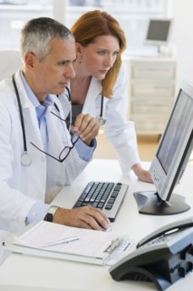Healthcare professionals looking at computer.