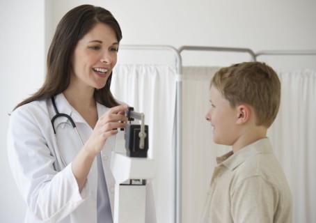 Young boy and doctor in examination room.