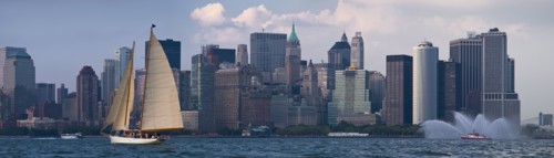 Sailboat on river in front of Lower Manhattan.