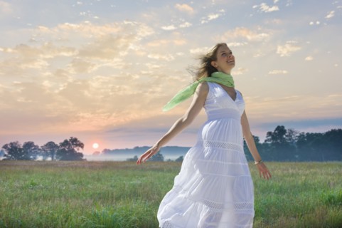 Carefree woman in field.