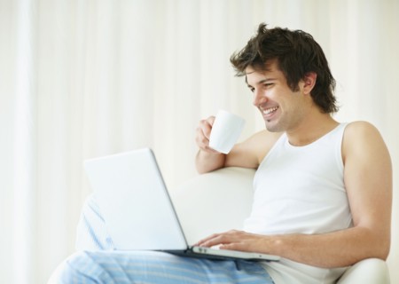 Relaxed man browsing the internet. Photo. momentimages