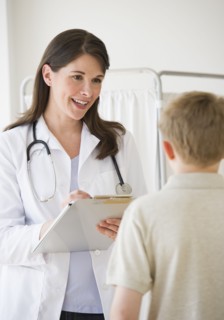 Young boy and doctor in examination room.