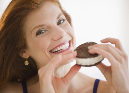 Woman eating an ice cream sandwich. Photo. Jamie Grill