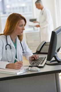 Doctor working on computer.