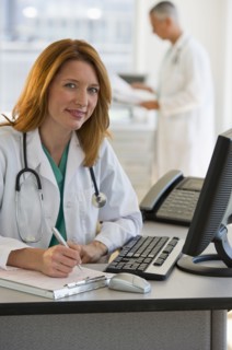 Doctor working on computer.