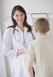 Young boy and doctor in examination room.