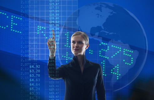 Businesswoman looking at numbers on screen.