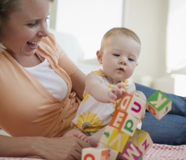 Mother and baby playing with blocks. Photo. Jamie Grill