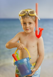 Young boy playing at the beach. Photo. Daniel Grill