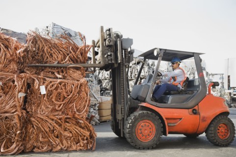 Forklift driver working at recycling plant.