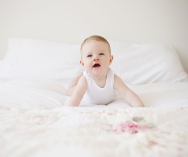 Baby on bed. Photo : Jamie Grill