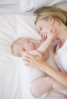 Mother and baby lying down together. Photo : Jamie Grill