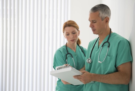 Healthcare professionals looking at medical chart.