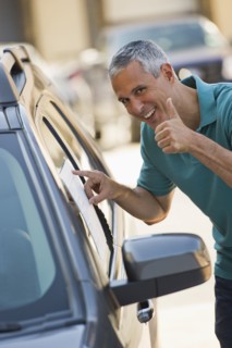 Man looking at new car.