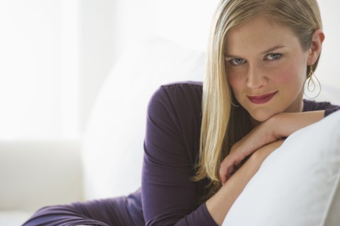 Sophisticated woman relaxing on couch.